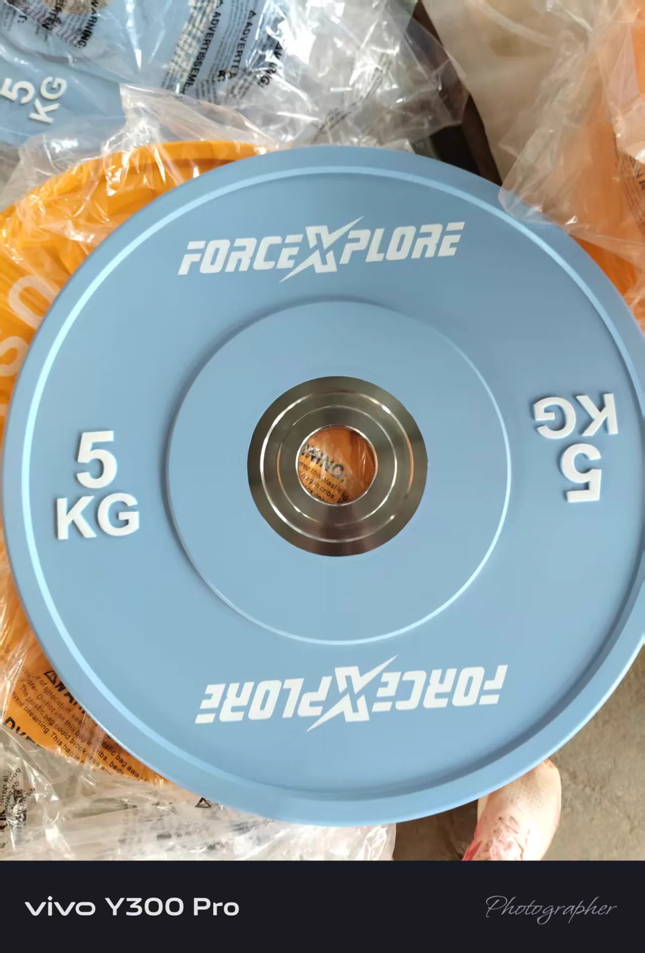 Blue 5 kg custom weight plate for a coordinated commercial gym equipment range