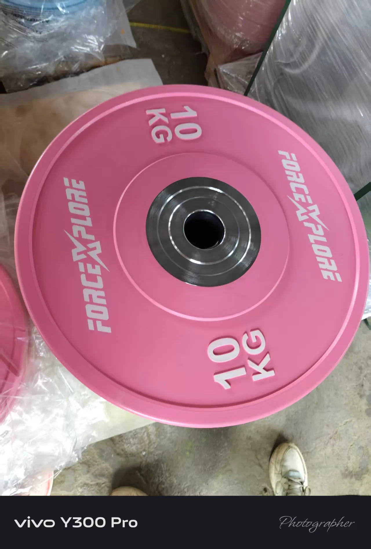 Pink custom weight plate made for a branded commercial gym equipment project