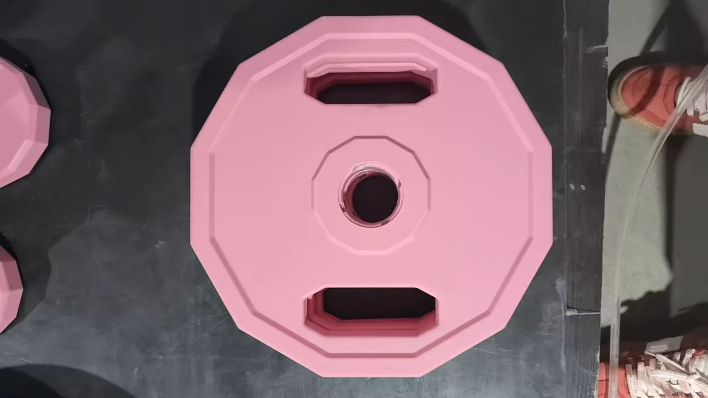 Custom pink multi-grip weight plate coordinated with an OEM dumbbell product range