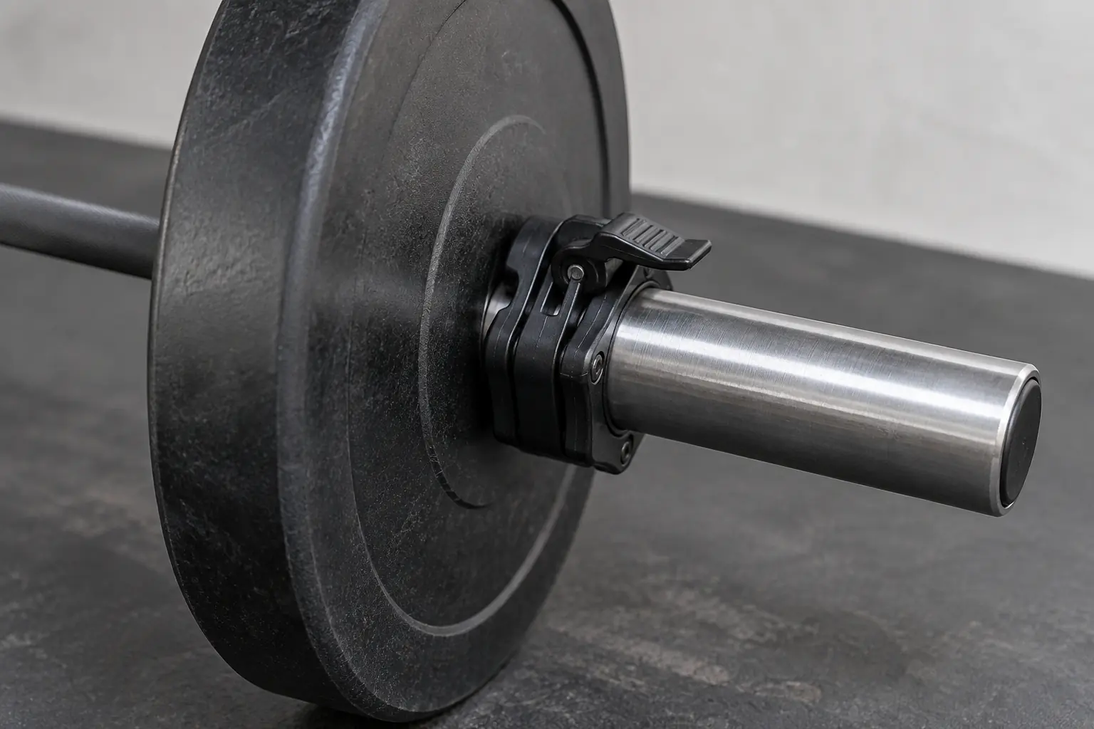 Unbranded lever collars fitted outside bumper plates on an Olympic barbell sleeve