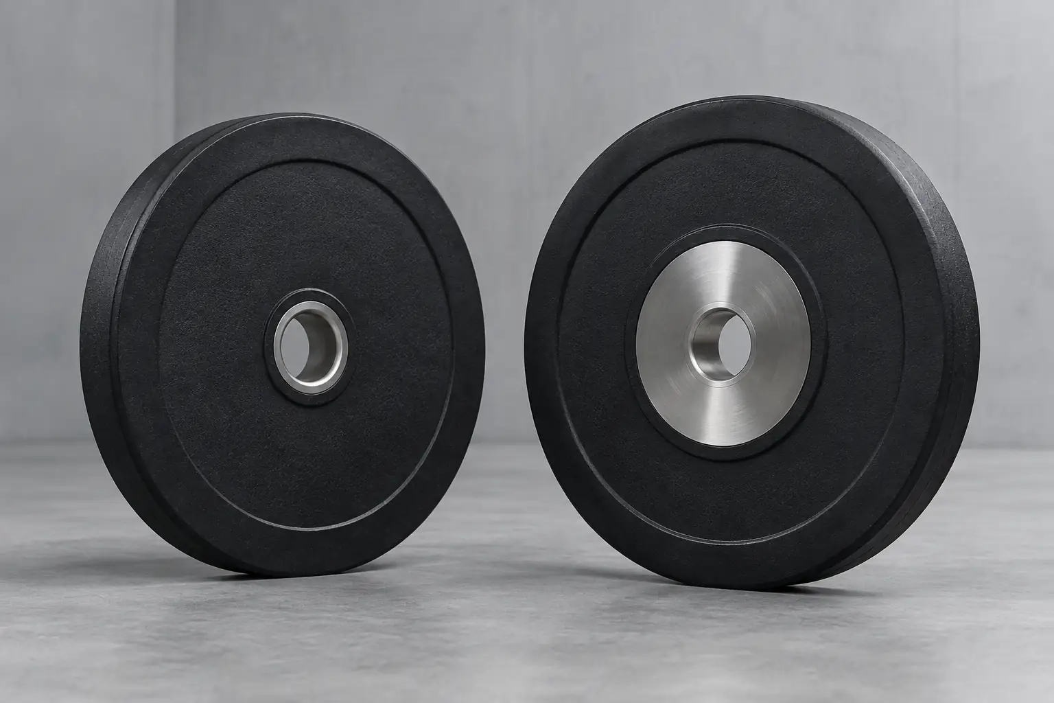 Unbranded bumper plates comparing narrow rings and broad hub assemblies