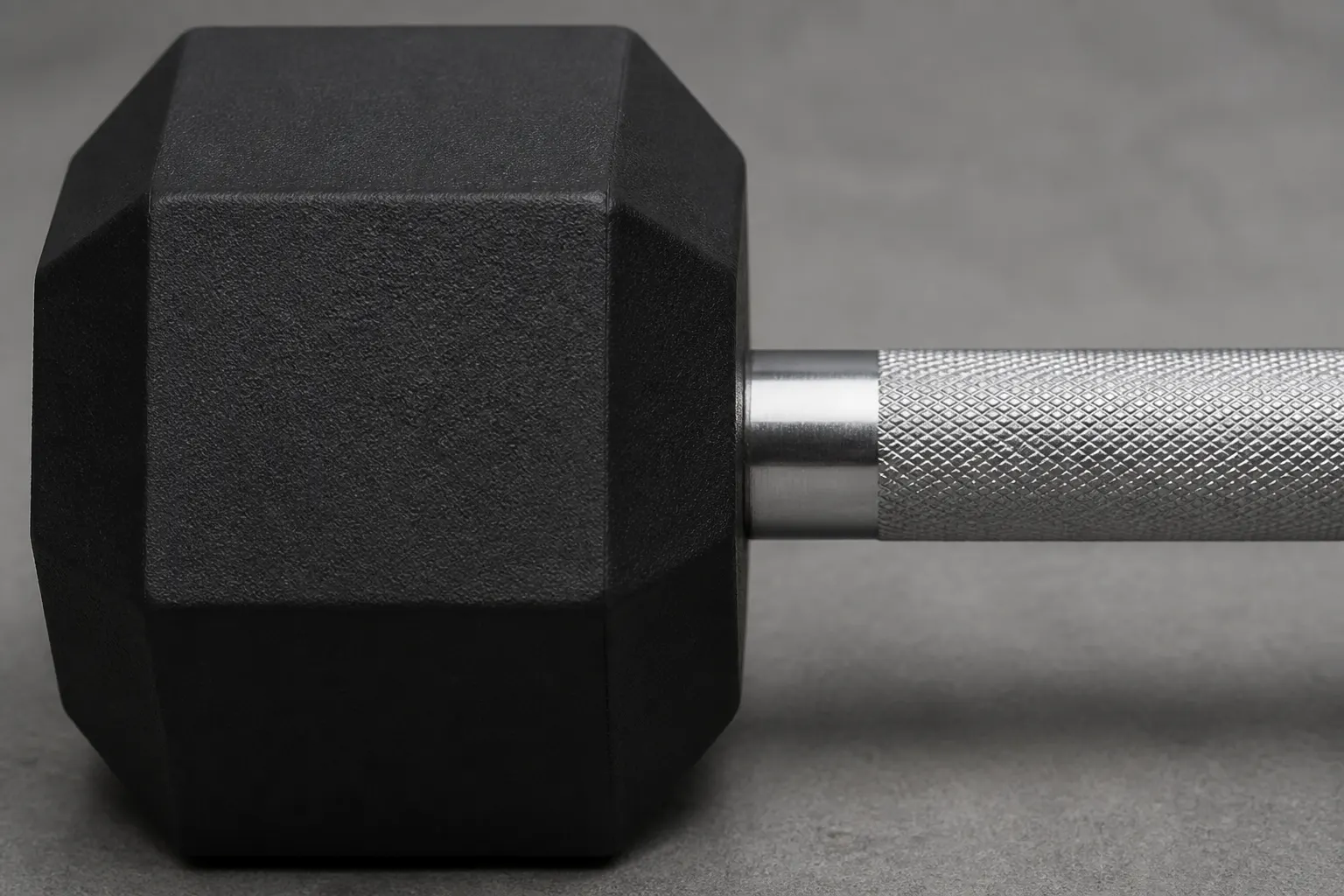 Close view of a steel handle shoulder entering a rubber hex head