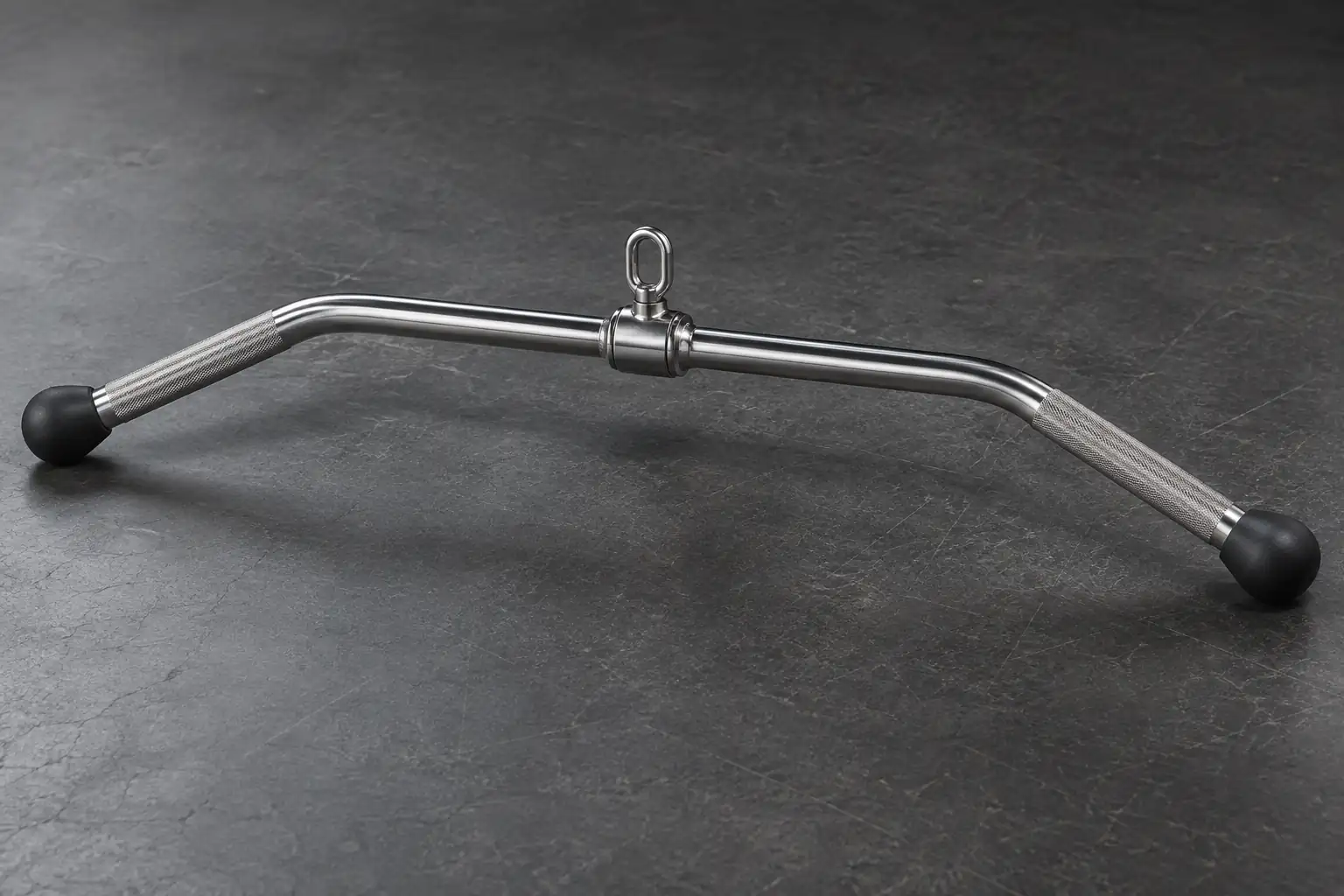 Unbranded commercial lat pulldown bar with a centered swivel on a studio surface